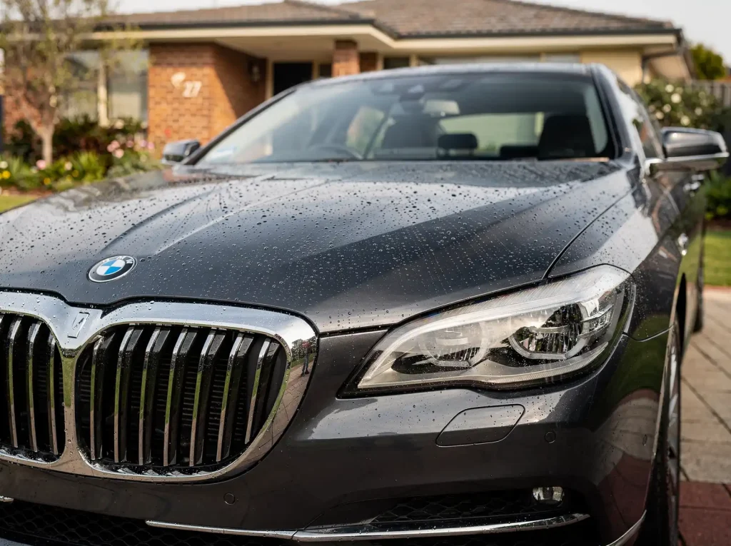 Freshly detailed premium saloon with mirror-finish paint and polished chrome grille in Perth.
