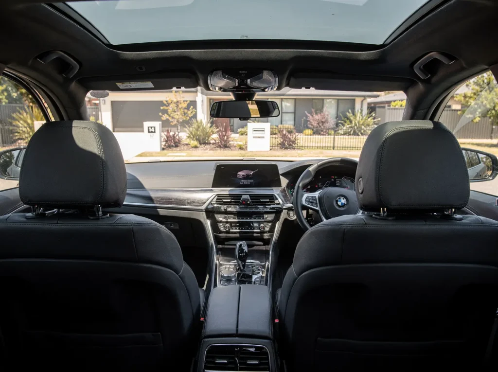 Freshly detailed sedan interior in Perth with spotless black leather and streak-free glass.