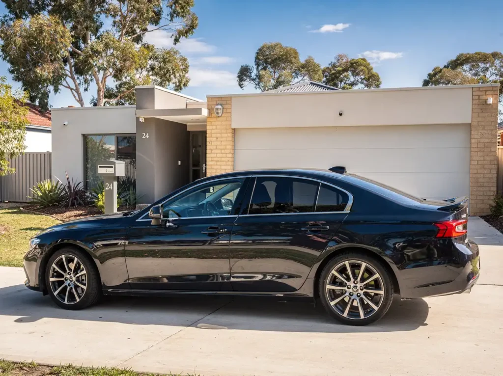 Freshly detailed car on a clean Perth forecourt with sky reflections across flawless paint.