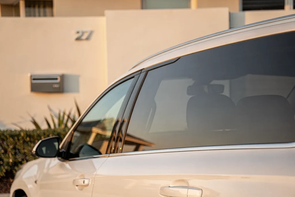 Glossy freshly detailed car finish reflecting light at a Perth home.