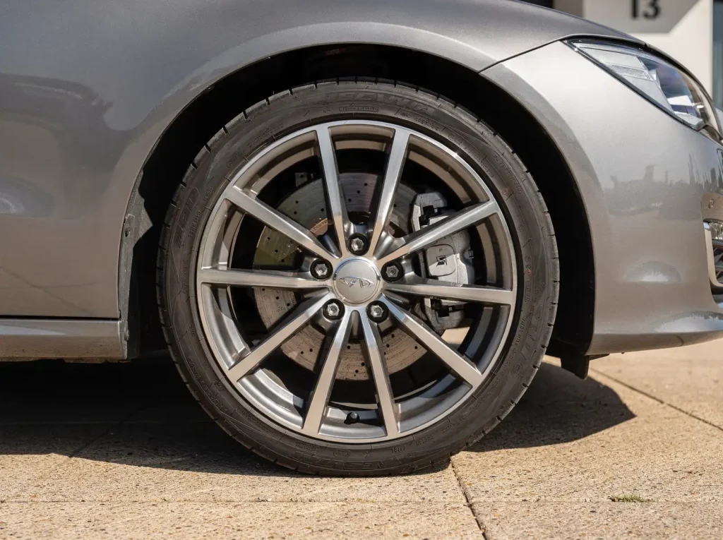 Freshly polished alloy wheel with dressed tyre and clean painted caliper after Perth detailing.