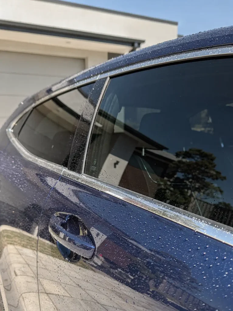 Water beads on glossy swirl-free paint after Perth car detailing.