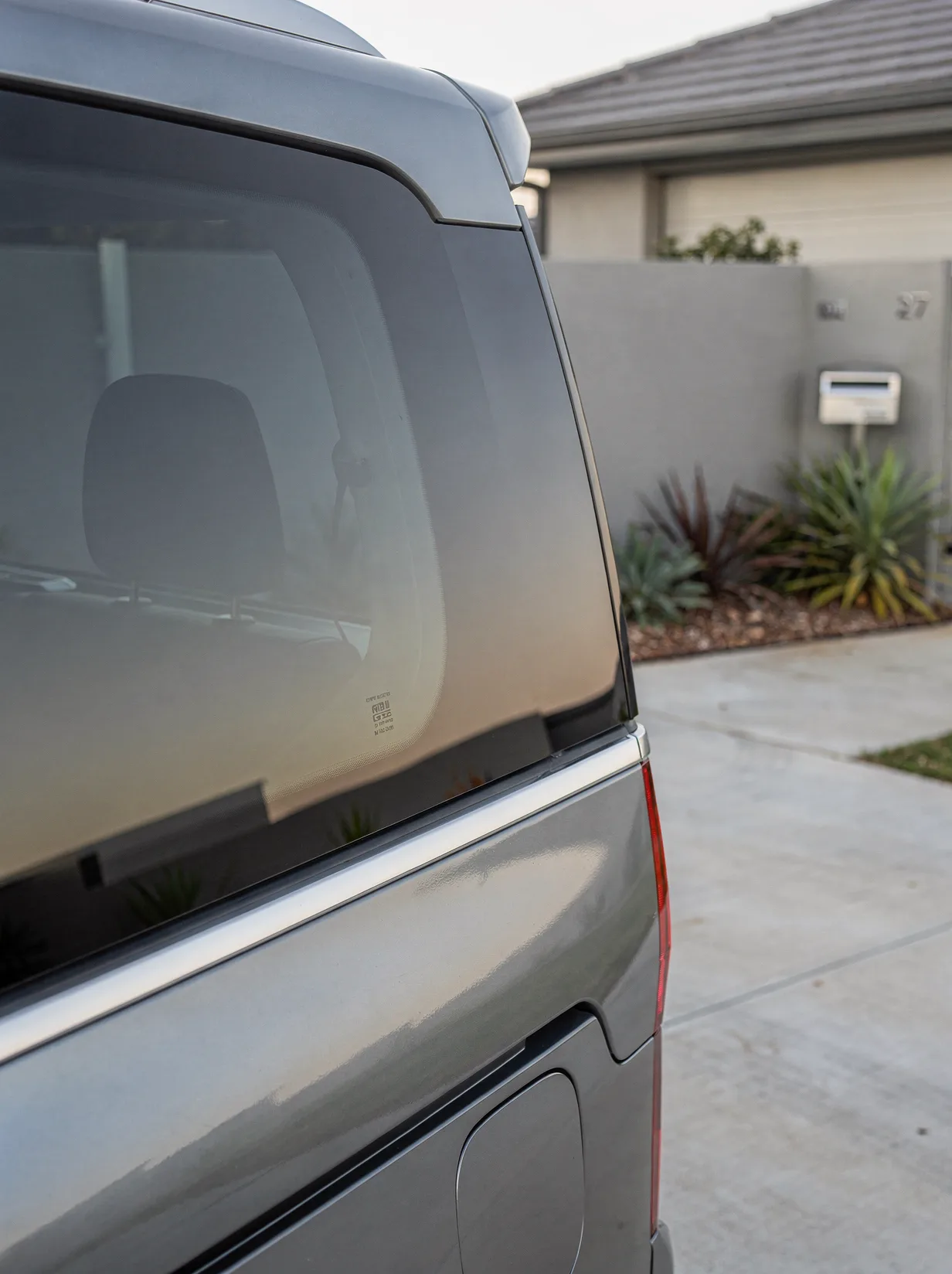 Paint-corrected car panel with mirror gloss reflecting an overhead light in Perth.